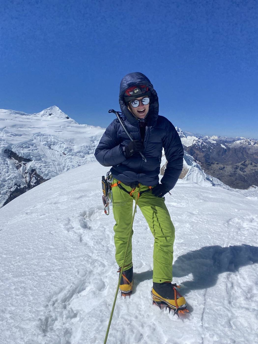 Shea McCrary roped up on a summit above a sea of cloud, Cordillera Blanca, Peru