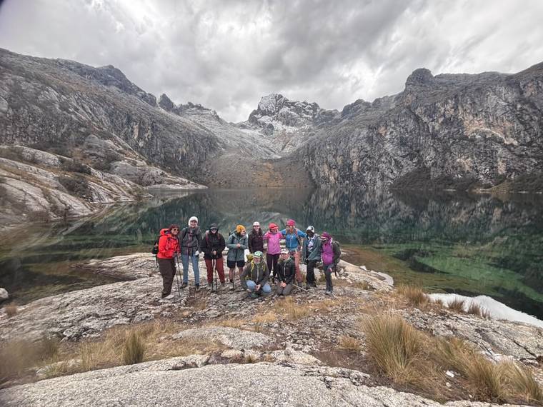 An AWExpeditions team at a glacial laguna in the Cordillera Blanca